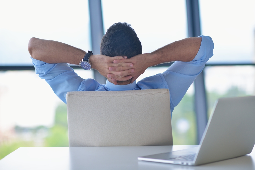 happy young business  man work in modern office on computer